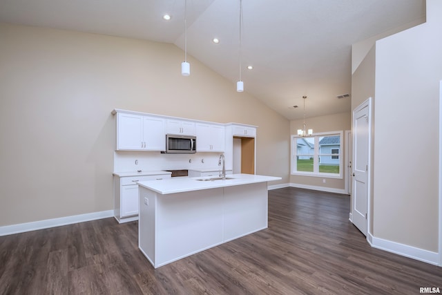 125 Beacon Harbor Cir, East Moline, IL 61244 - kitchen with a sink, white cabinetry, a center island with sink, stainless steel microwave, and an inviting chandelier