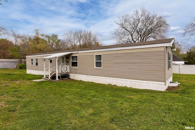 back of house featuring a lawn