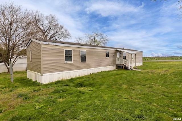 back of house featuring a lawn