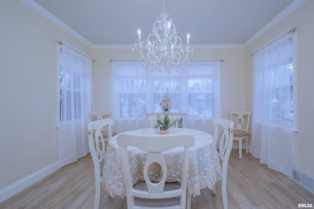 dining space featuring crown molding, a notable chandelier, and light wood-type flooring