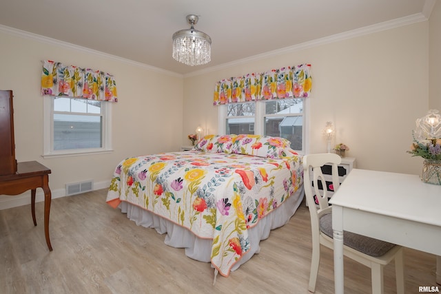 bedroom with multiple windows, light hardwood / wood-style flooring, a notable chandelier, and ornamental molding