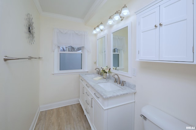 bathroom with hardwood / wood-style floors, vanity, toilet, and ornamental molding