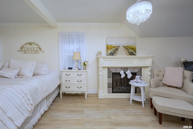 bedroom with beam ceiling, a tile fireplace, crown molding, and light hardwood / wood-style flooring