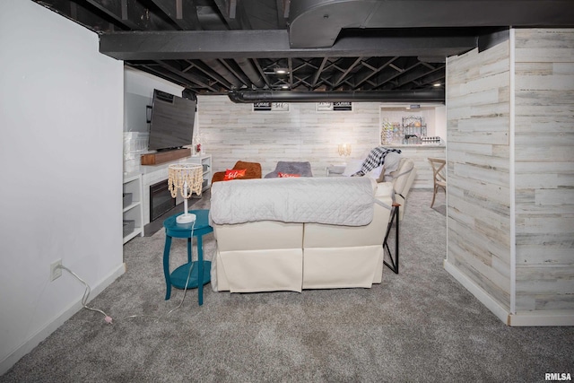 carpeted bedroom with wooden walls