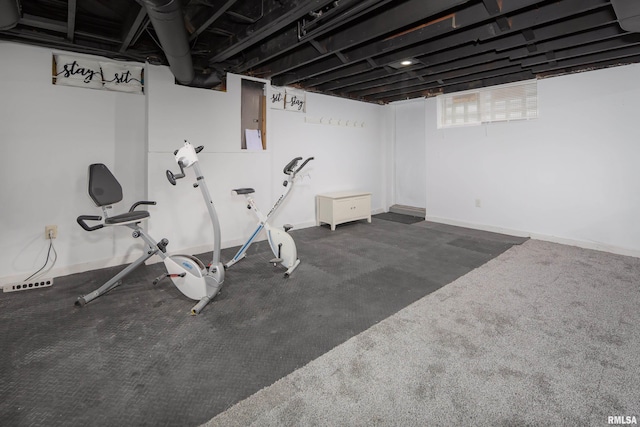 exercise room featuring dark colored carpet