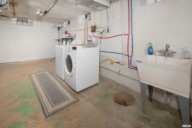 clothes washing area featuring washer and dryer and sink