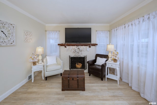 sitting room with a fireplace, light hardwood / wood-style floors, and ornamental molding