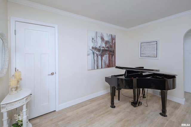 misc room with light wood-type flooring and ornamental molding