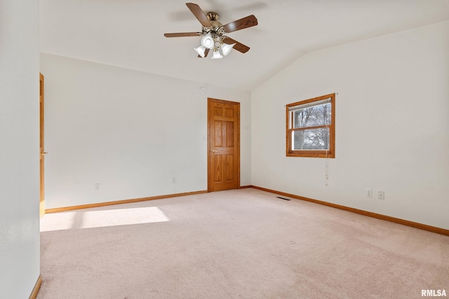 carpeted spare room with ceiling fan and lofted ceiling