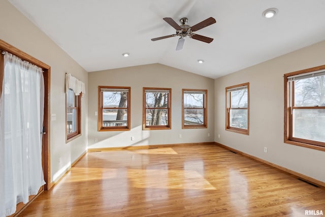 interior space with ceiling fan, light hardwood / wood-style floors, a wealth of natural light, and vaulted ceiling