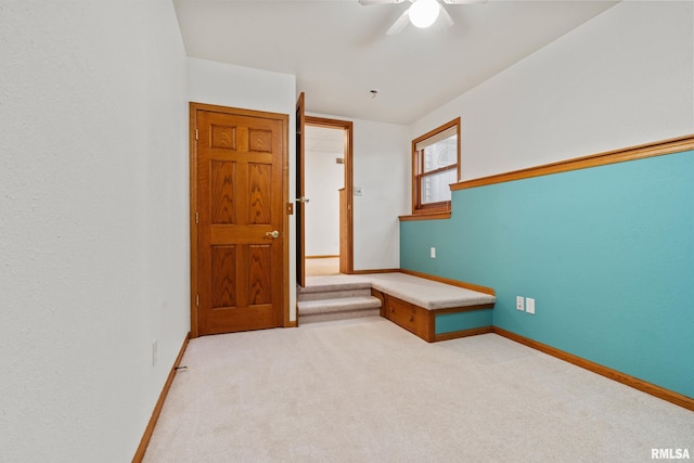 carpeted empty room featuring ceiling fan