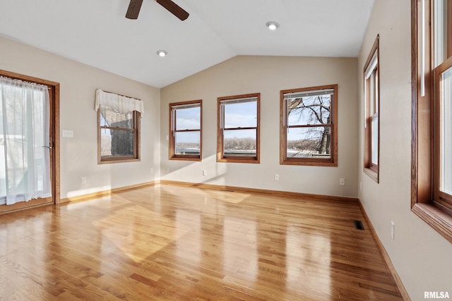 spare room featuring ceiling fan, light hardwood / wood-style flooring, and lofted ceiling