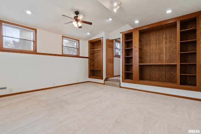 unfurnished bedroom featuring light carpet, ceiling fan, and vaulted ceiling