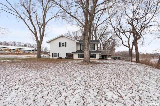 snow covered property with a wooden deck