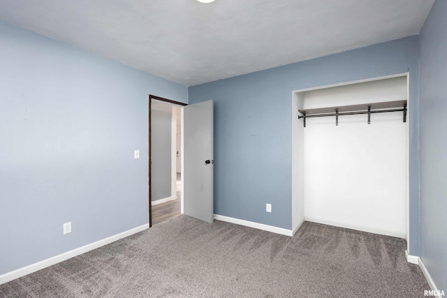 unfurnished bedroom featuring carpet and a closet