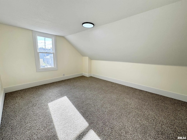 bonus room featuring carpet flooring, a textured ceiling, and lofted ceiling