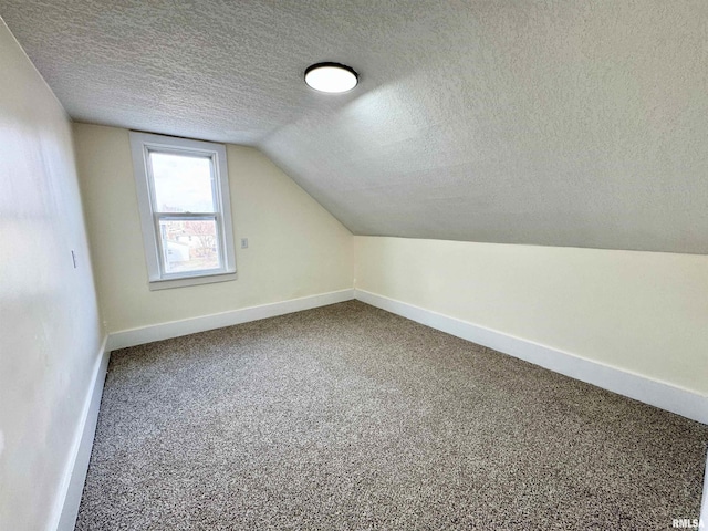 bonus room with carpet flooring, a textured ceiling, and lofted ceiling