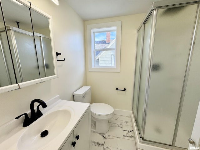 bathroom with vanity, toilet, and an enclosed shower