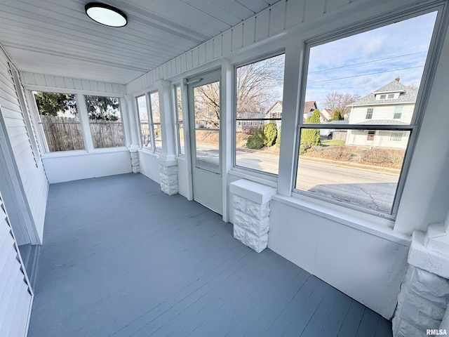 unfurnished sunroom with wooden ceiling