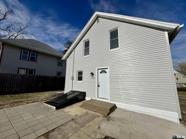 back of property with a patio