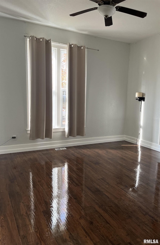 unfurnished room featuring ceiling fan and dark hardwood / wood-style flooring