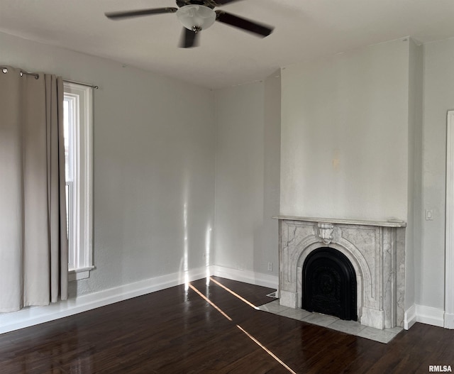 unfurnished living room featuring a fireplace, ceiling fan, and hardwood / wood-style floors