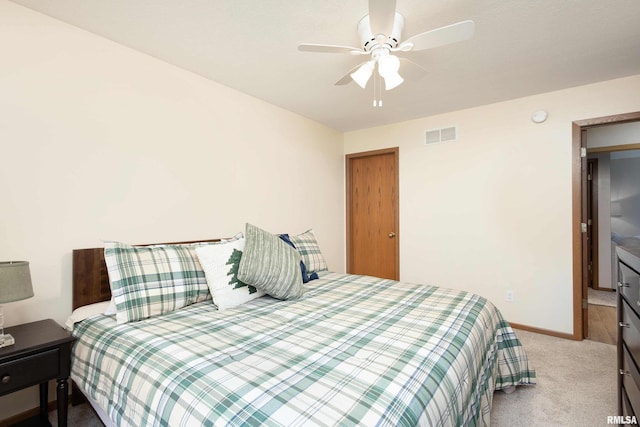 bedroom with ceiling fan and light colored carpet