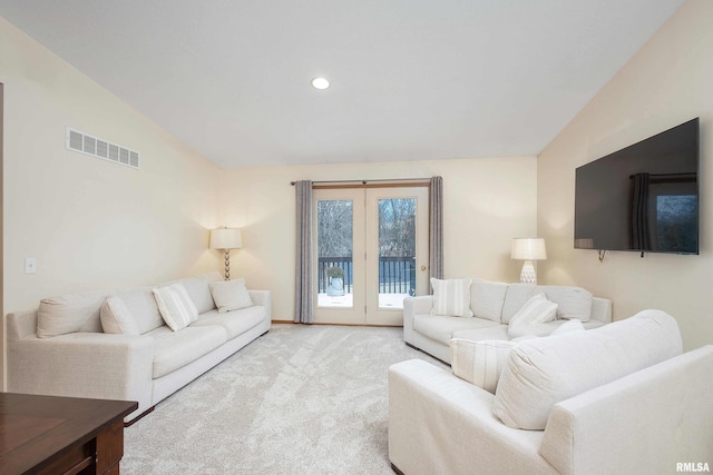 living room with light colored carpet and vaulted ceiling