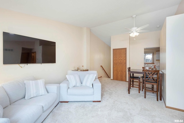 carpeted living room with ceiling fan and lofted ceiling