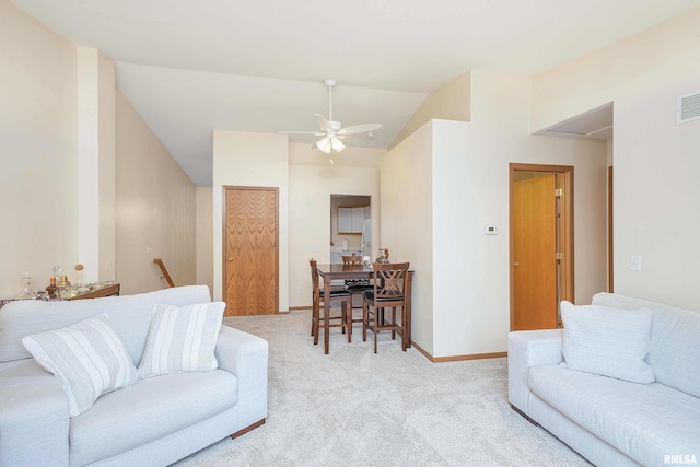 carpeted living room featuring ceiling fan and vaulted ceiling