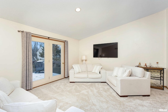 living room featuring light colored carpet and vaulted ceiling