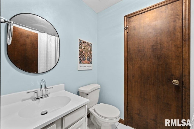 bathroom with tile patterned floors, vanity, and toilet