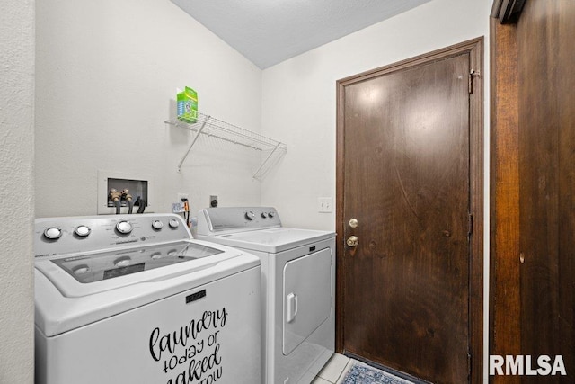 washroom with separate washer and dryer and light tile patterned floors