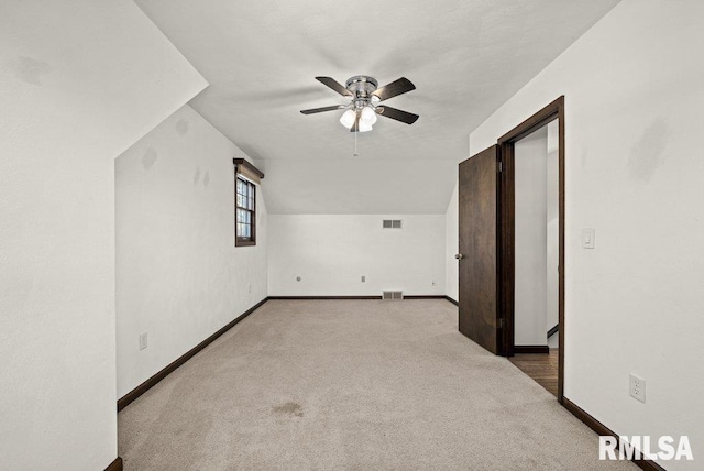 bonus room with ceiling fan, light carpet, and vaulted ceiling