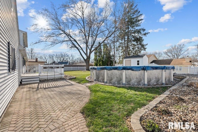 view of yard with a swimming pool side deck