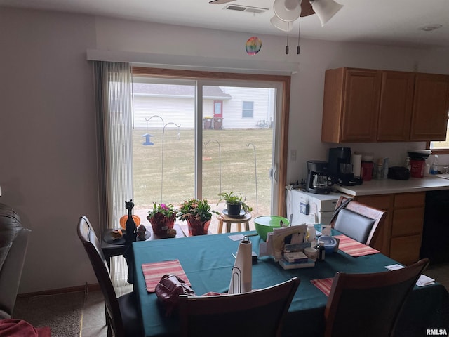 dining area with baseboards, visible vents, and a ceiling fan