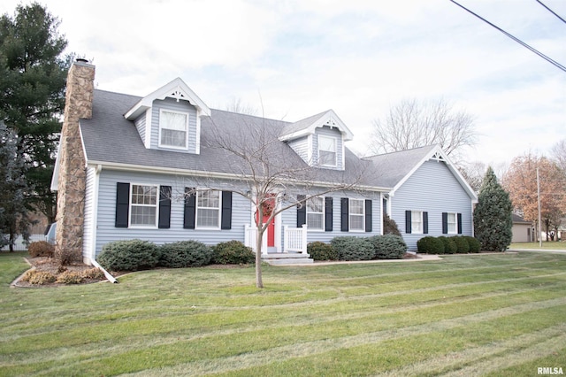 cape cod house with a front lawn