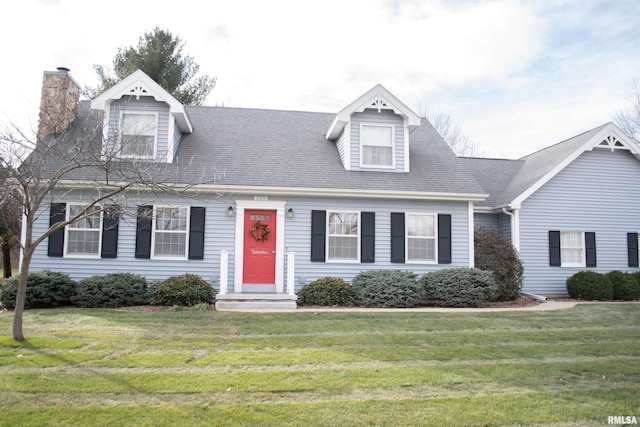 new england style home with a front yard