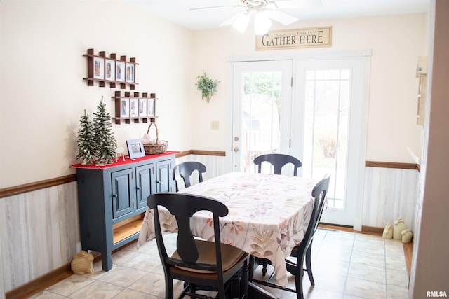 tiled dining area featuring ceiling fan