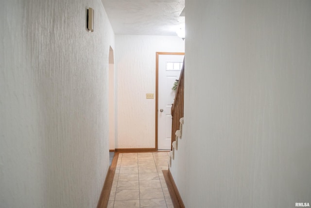 hall with light tile patterned floors