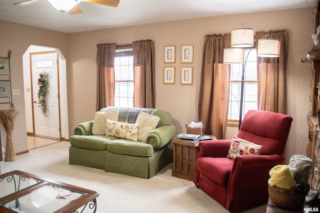 carpeted living room featuring ceiling fan