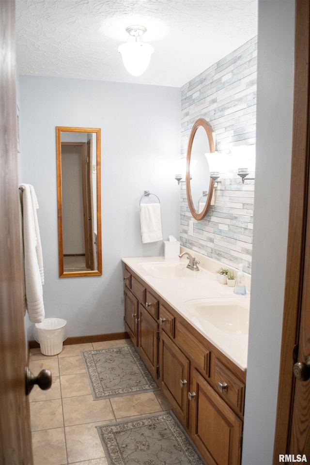 bathroom with decorative backsplash, a textured ceiling, vanity, and tile patterned floors