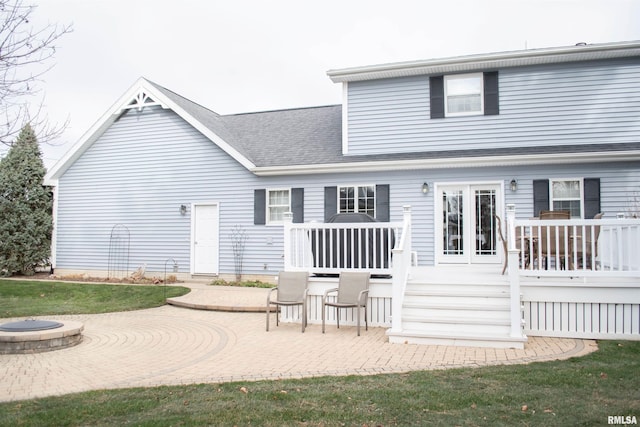 rear view of house with a patio, an outdoor fire pit, and a wooden deck