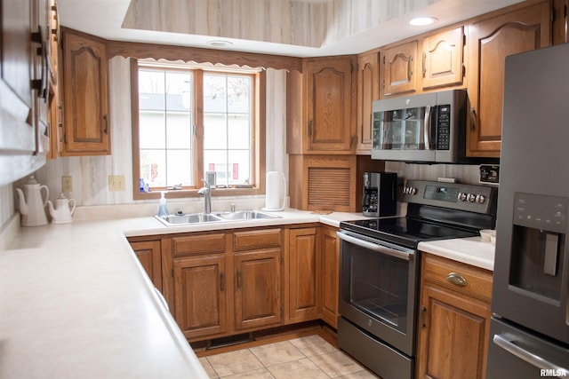 kitchen featuring sink, light tile patterned floors, and stainless steel appliances