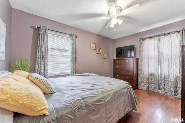 bedroom featuring ceiling fan and dark hardwood / wood-style floors