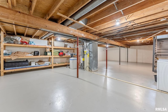 basement featuring heating unit and washer / clothes dryer