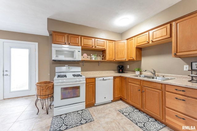 kitchen with light tile patterned floors, white appliances, and sink