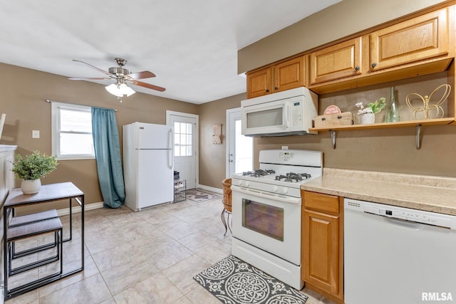 kitchen featuring ceiling fan, light tile patterned floors, and white appliances