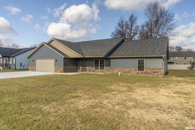 view of front of house featuring a garage and a front lawn