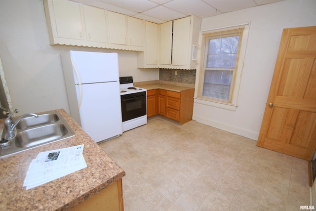 kitchen featuring white appliances, backsplash, a paneled ceiling, and sink